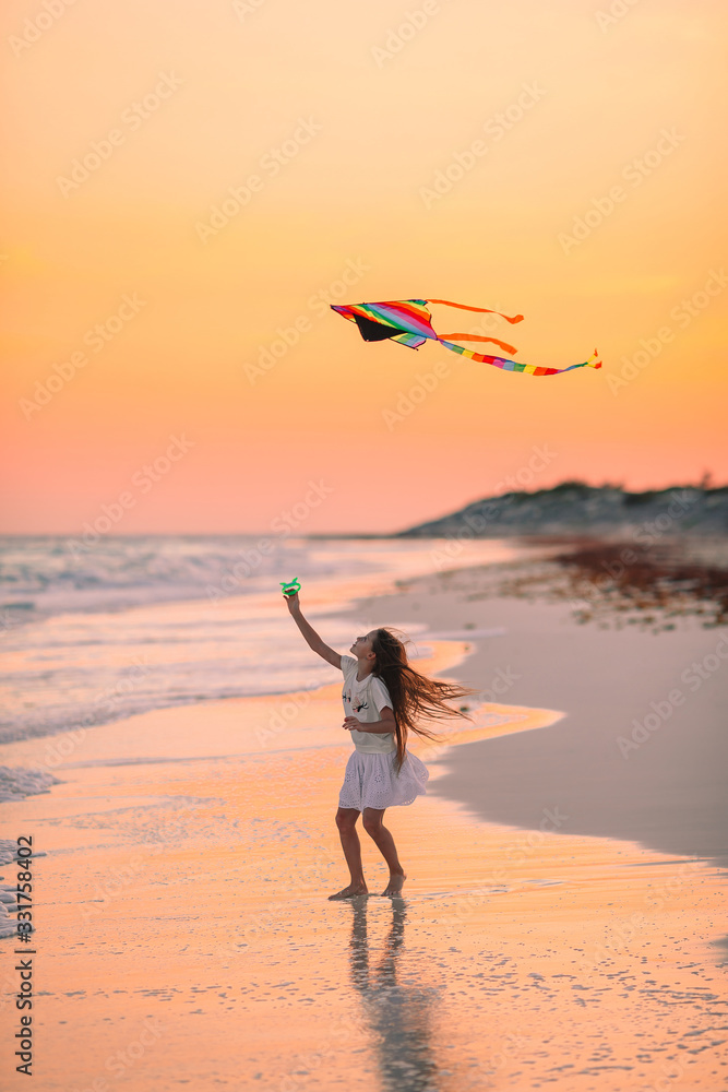 Adorable happy little girl on white beach at sunset. Stock Photo ...