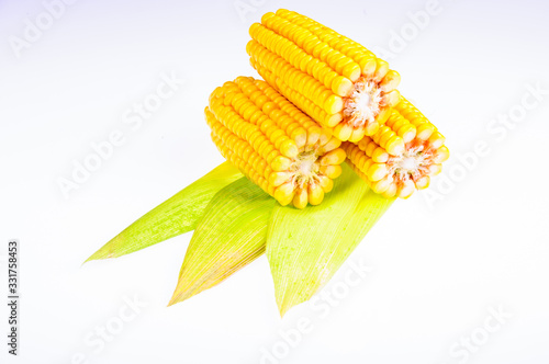 Ripe corn on the cob on a white background photo