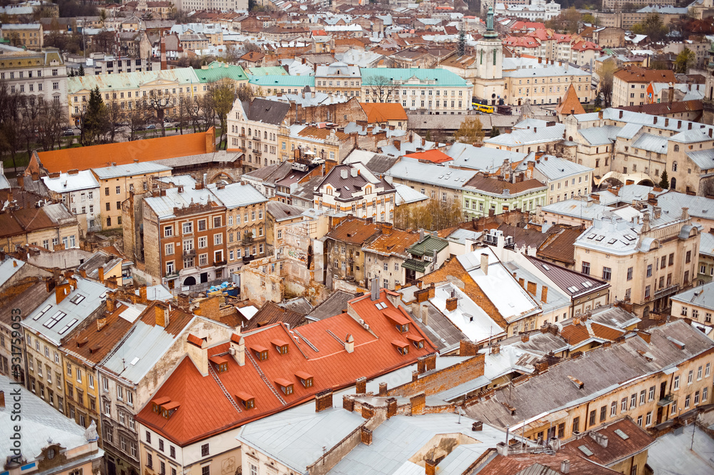Lviv old city vintage panorama with houses roofs top view, Lviv, Ukraine. Retro travel industrial photo background.