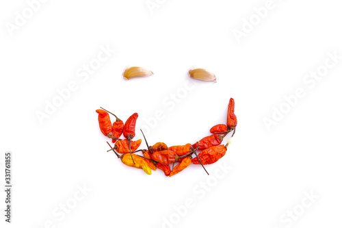 red chili and garlic to form a smiling face isolated from a white background and copy space