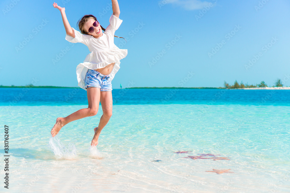 Adorable happy little girl have fun on beach vacation Adorable happy little girl have fun on beach vacation