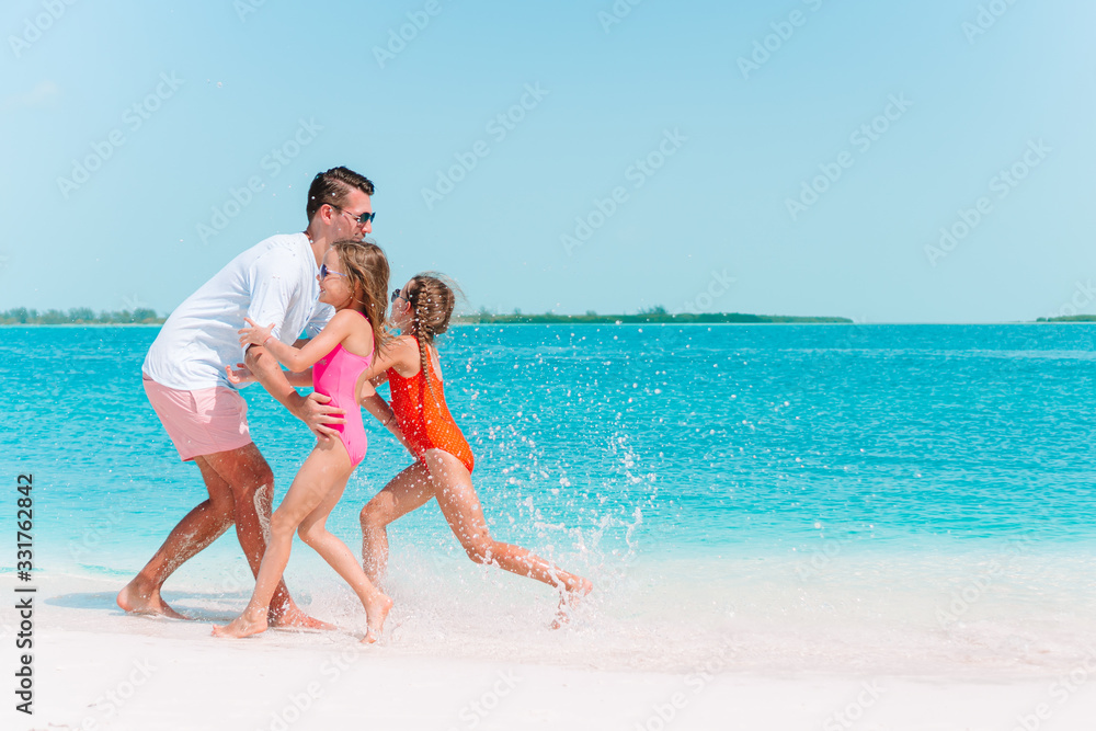 Happy beautiful family on a tropical beach vacation