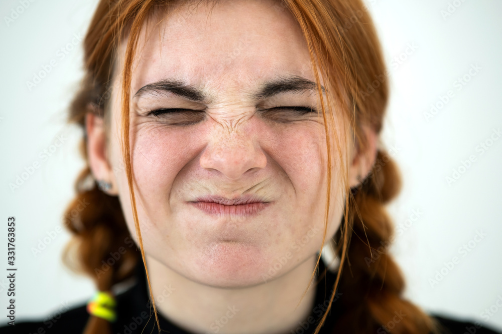 Close up portrait of angry redhead teenage girl. Close up portrait of angry redhead teenage girl.