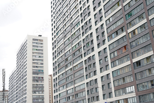 Frontal view of facade of building with a lot of windows. © goldeneden