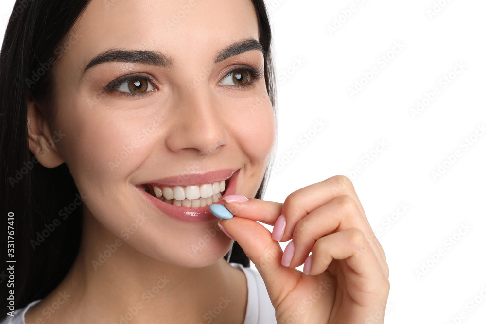 Young woman taking vitamin pill on white background, closeup Young woman taking vitamin pill on white background, closeup