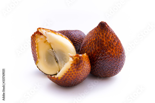 salacca or thorny palm fruit that has been peeled and intact, isolated white background and copy space, scientific name: Salacca zalacca