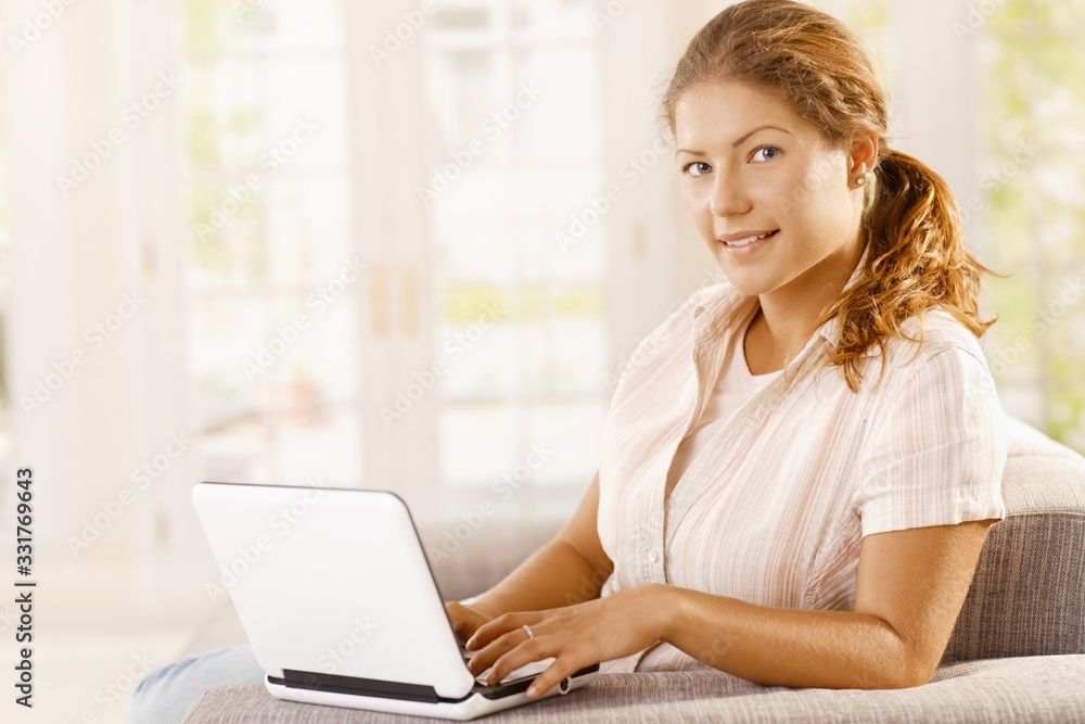 Stay at home home office - Young woman working on computer at home Stay at home home office - Young woman working on computer at home