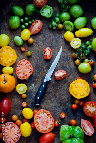 Fresh organic multi-colored tomatoes with knife