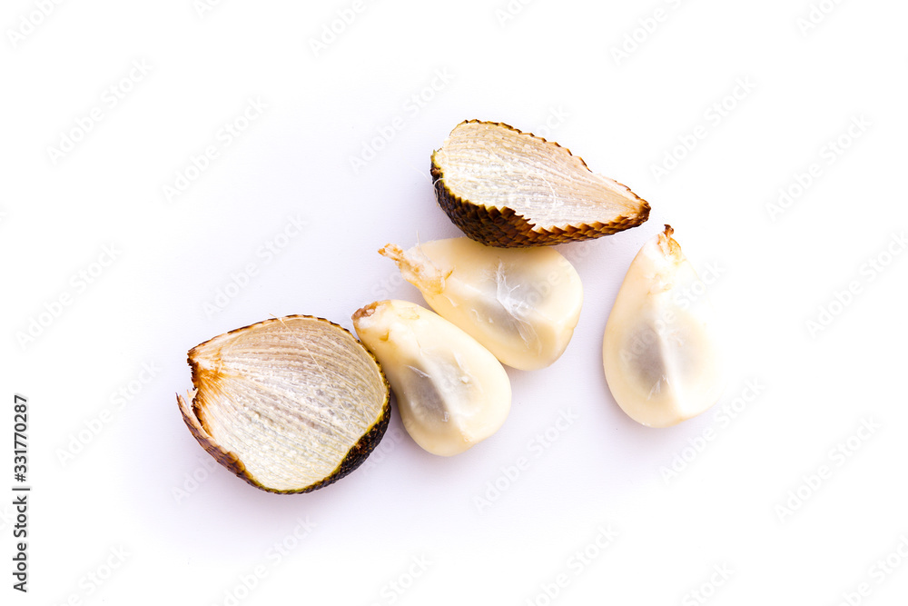 salacca or thorny palm fruit that has been peeled and intact, isolated white background and copy space, scientific name: Salacca zalacca