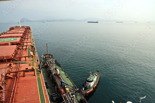 Bunkering of a ship on the open roadstead of the port of Nakhodka, Russia.