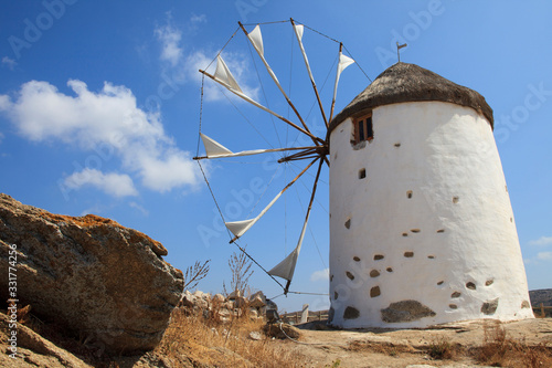 Vivlos, Naxos / Greece - August 25, 2014: Traditional windmill at the mountain village Vivlos, Naxos, Cyclades Islands, Greece photo