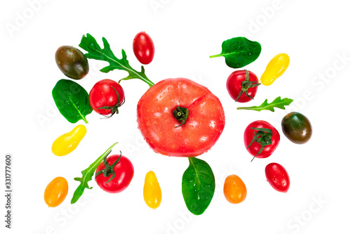 Fresh colorful cherry tomatoes  arugula leaves and basil on white background  raw food and vegetable concept