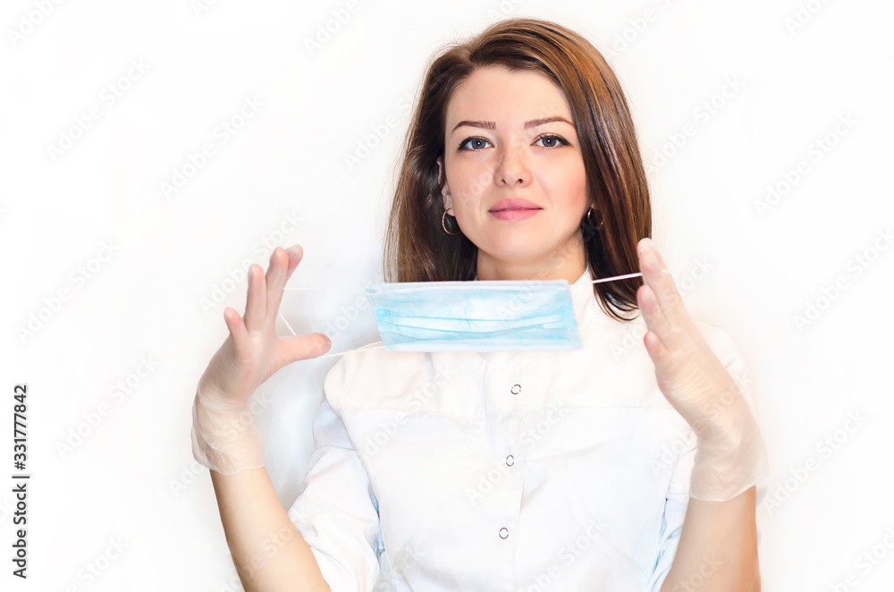 girl nurse, woman, lady puts on medical mask, gloves to protect her health from the virus, prevention of viral diseases, from the epidemic.. girl nurse, woman, lady puts on medical mask, gloves to protect her health from the virus, prevention of viral diseases, from the epidemic..