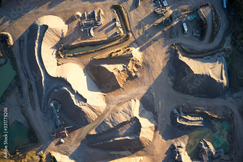 Quarry works industrial digging aerial view from above showing sand mound and hills