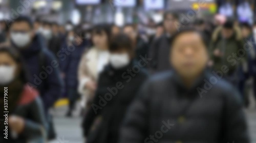 4K, Blurred defocused view of Large crowd people wearing surgical mask walking in subway exit. Coronavirus pneumonia has been spreading into many cities. 2019-nCoV epidemic of China.-Dan photo