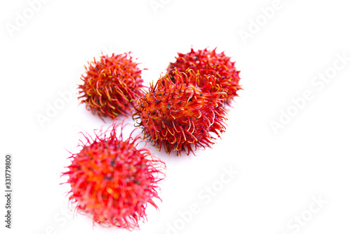 ripe red rambutan fruit, isolated white background and copyspace, scientific name: Nephelium lappaceum