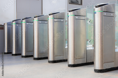 access control systems, passage is allowed, the concept. Turnstiles are open, chrome turnstiles with green resolving signal.