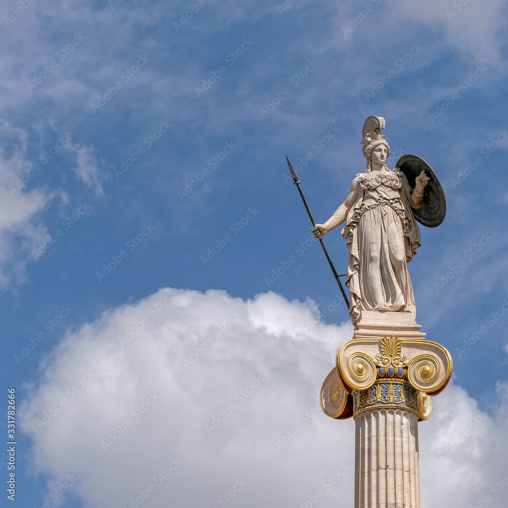 Athena marble statue the ancient greek goddess of knowledge and wisdom under blue sky with clouds, some space for text Athena marble statue the ancient greek goddess of knowledge and wisdom under blue sky with clouds, some space for text