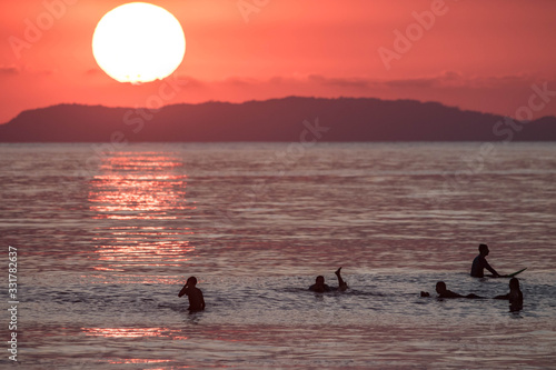 Fototapeta Naklejka Na Ścianę i Meble -  surfing sunset Jaco beach costa rica