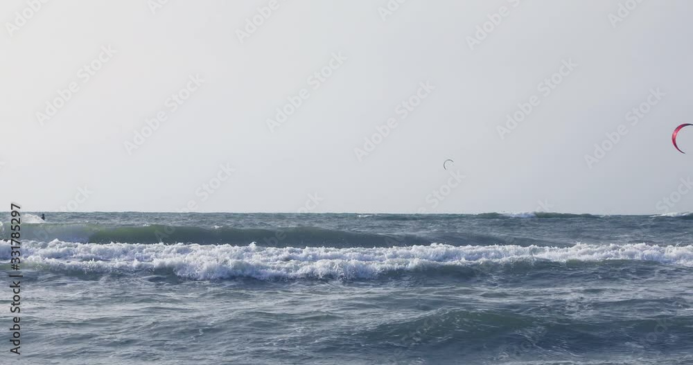 Surfers floating on the waves of the Mediterranean Sea Surfers floating on the waves of the Mediterranean Sea