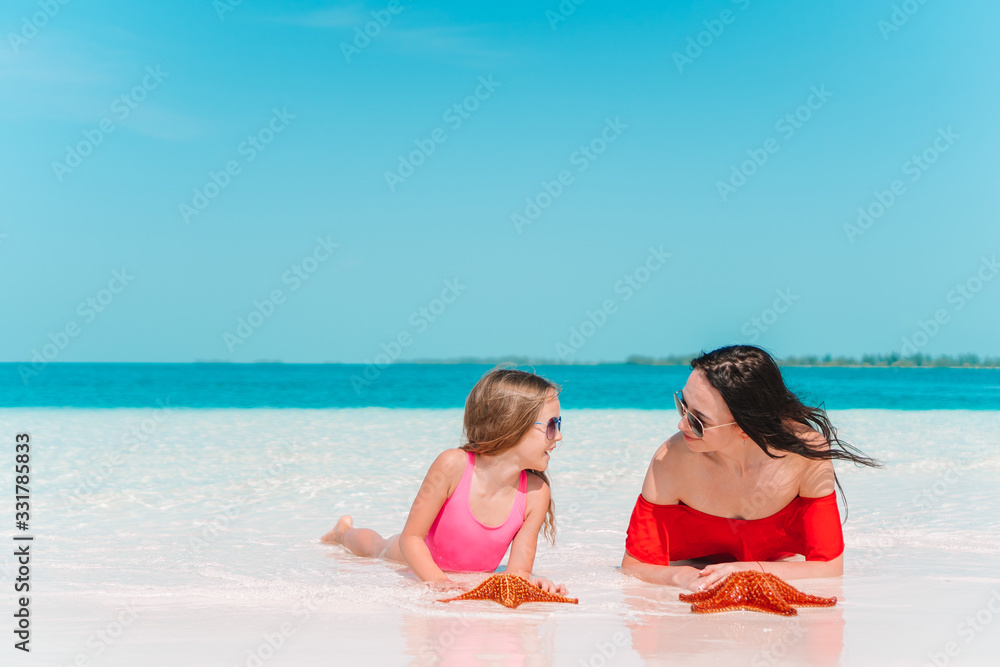 Beautiful mother and daughter on the beach Beautiful mother and daughter on the beach