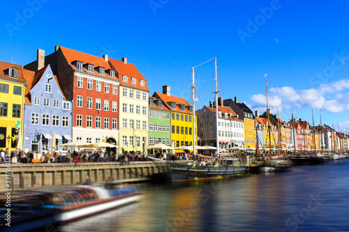 Photography Scenic summer view of Nyhavn pier with color buildings, ships, yachts and other