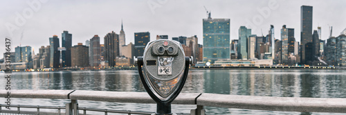 Panorama of tourist binoculars with Manhattan, New York City skyline in the background © quietbits