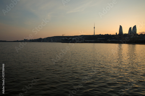 Night view of Baku and the seaside of the Caspian sea. Sunset in Baku. Colorful sunset on the Baku boulevard . The seaside of the Caspian sea . Panorama Baku city in he morning, Azerbaijan .