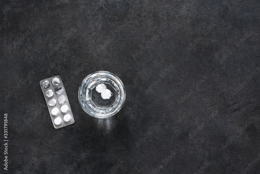 Tablets and glass of water on a concrete background. Tablets and glass of water on a concrete background.
