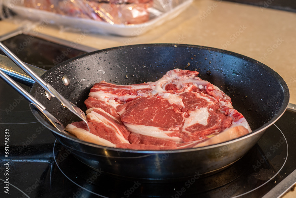 piece of steak being cooked in the pan piece of steak being cooked in the pan