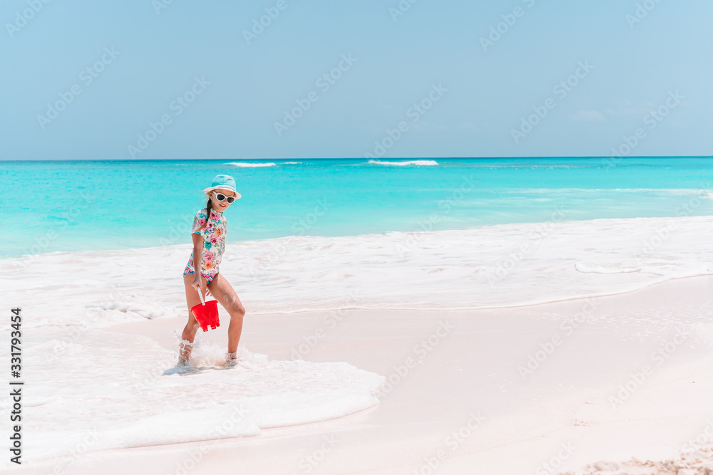 Portrait of adorable little girl at beach during summer vacation Portrait of adorable little girl at beach during summer vacation