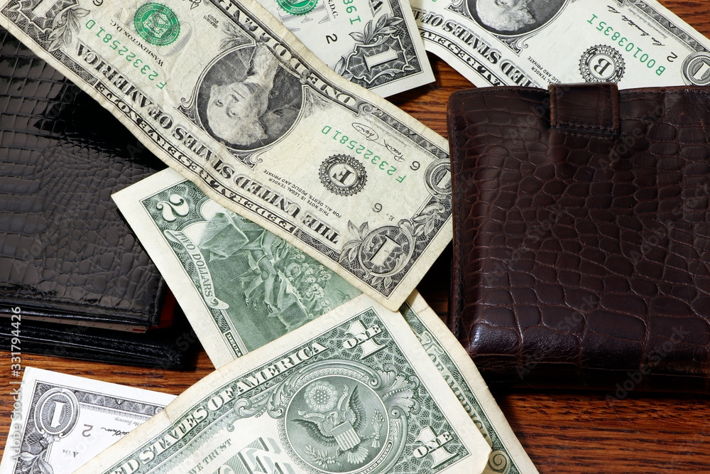 Dollars, money and wallet on a wooden table. One dollar. Purse with money. Dollars, money and wallet on a wooden table. One dollar. Purse with money.