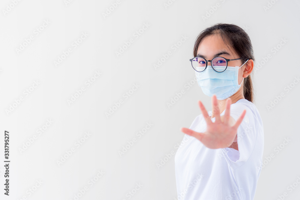 Portrait Asian young woman wears glasses and mask to protect against Coronavirus looking at camera, girl show hands stop coronavirus outbreak isolated on white background stop virus Covid 19 concept Portrait Asian young woman wears glasses and mask to protect against Coronavirus looking at camera, girl show hands stop coronavirus outbreak isolated on white background stop virus Covid 19 concept