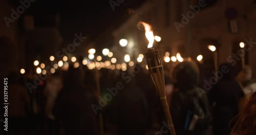 Torchlight procession at night people with burning torches