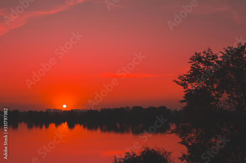 Fototapeta Naklejka Na Ścianę i Meble -  Red saturated sunset on the river