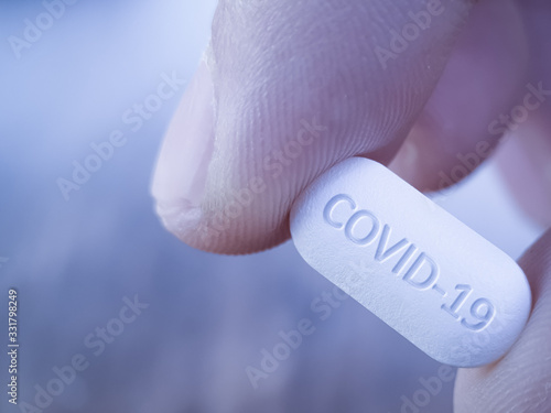 COVID 19 Coronavirus Cure drug concept in one tablet. Concept for antiviral drug for new korona virus. Medication pharmaceutical for Corona treatment. Close up concept for Covid Cure photo