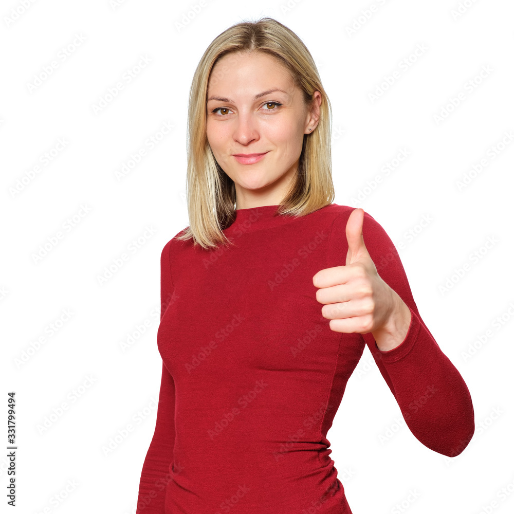 Young blonde caucasian woman wears informal warm red sweater showing thumb Young blonde caucasian woman wears informal warm red sweater showing thumb