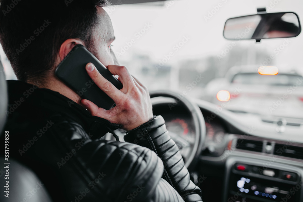 Car driver talking on the phone and driving. Car driver talking on the phone and driving.