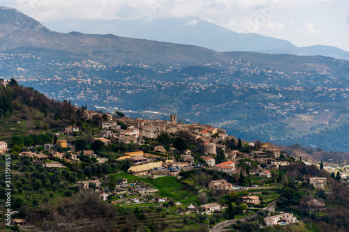 A close-up panoramic view of the old French town Saint-Jeannet and its medieval architecture with the low Alps mountains hills in the background (Provence / Riviera / Côte d'Azur)
