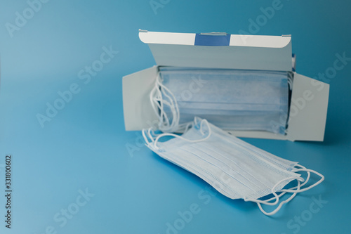 Medical respiratory bandage face on blue background. prevention of the spread of virus and pandemic COVID-19.