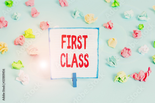 Handwriting text First Class. Conceptual photo the most expensive and most luxurious class of accommodation Colored crumpled papers empty reminder blue floor background clothespin photo