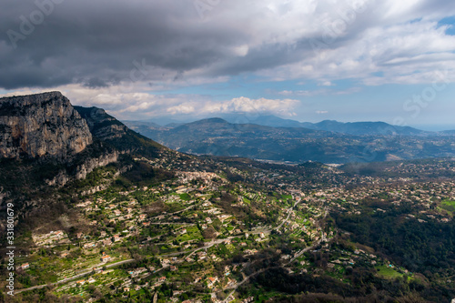 A wide / high angle panoramic view of Saint-Jeannet buildings and other towns covering the low Alps mountains hills with the mountain ranges in the haze (French Côte d'Azur/ Provence/ Riviera) © k.dei