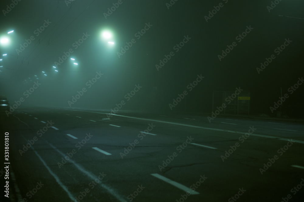 Highway road at night in the fog in the city