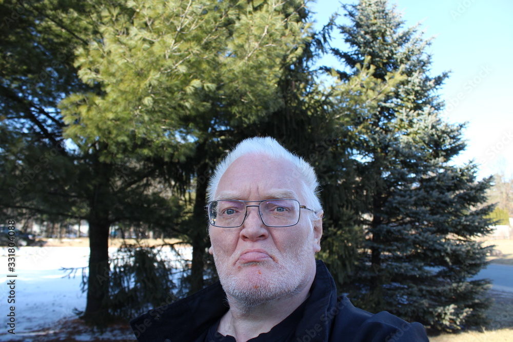portrait of senior man in park portrait of senior man in park