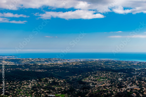 A wide   high angle panoramic view of buildings of several towns covering the low Alps mountains hills and the Mediterranean Sea coastline  French C  te d Azur  Provence  Riviera 