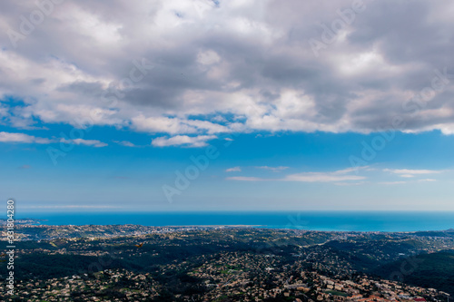 A wide   high angle panoramic view of buildings of several towns covering the low Alps mountains hills and the Mediterranean Sea coastline  French C  te d Azur  Provence  Riviera 