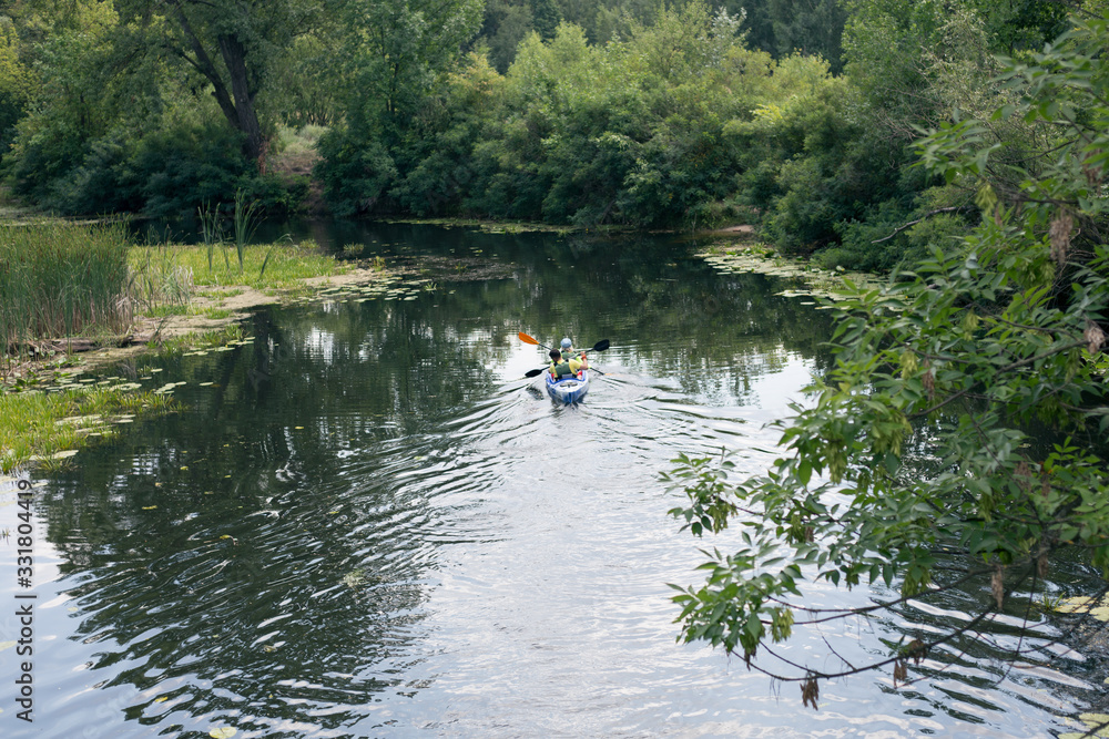 A guy and a girl canoe paddling the river