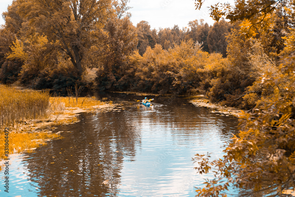 A guy and a girl canoe paddling the river in fall A guy and a girl canoe paddling the river in fall