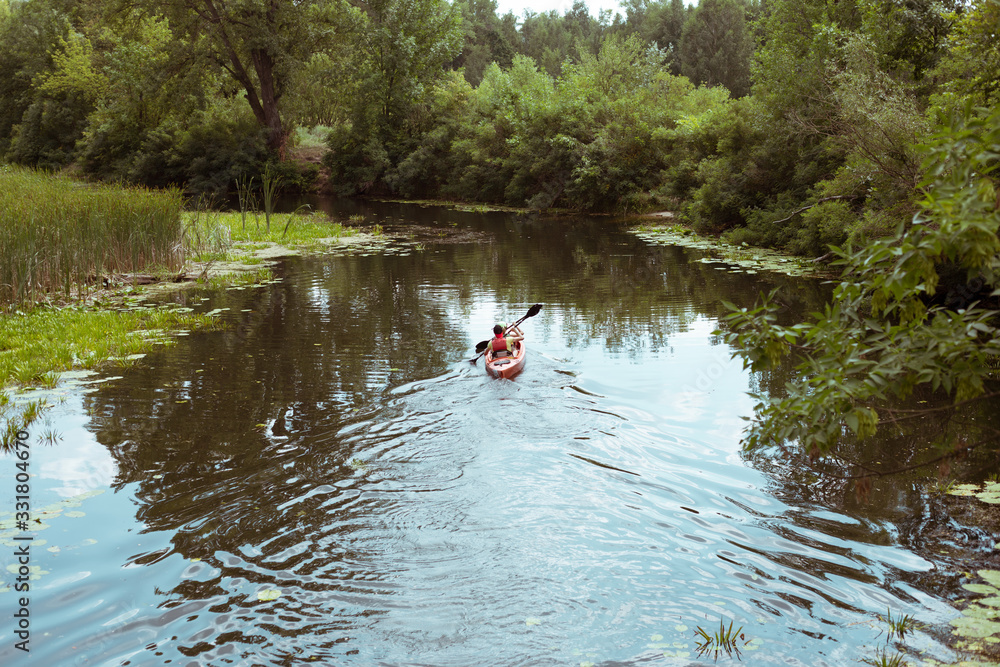 A guy and a girl canoe paddling the river