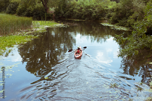 A guy and a girl canoe paddling the river